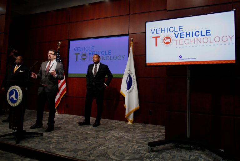 Transportation Secretary Anthony Foxx listens at right as National Highway Traffic Safety Administration Administration (NHTSA) Acting Administrator David Friedman, center, speaks about the Transportation Department's decision on vehicle-to-vehicle communication technology, Monday, Feb. 3, 2014, at the Transportation Department in Washington. Assistant Transportation Department Secretary for Research and Technology Greg Winfree is at left. . (AP Photo/Charles Dharapak)