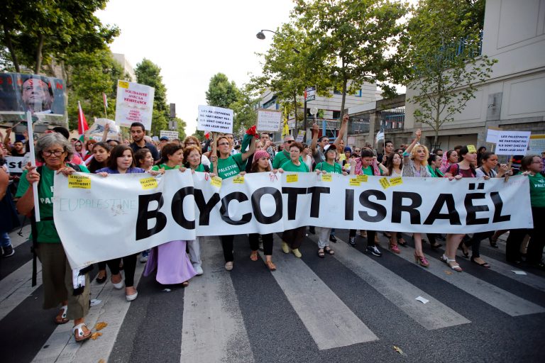 Pro-Palestinian demonstrators hold a banner and shout slogans, in Paris, France, Wednesday, July 23, 2014 during a demonstration to protest against the Israeli army's shelling in the Gaza strip. Protesters marched through Paris against the Israel-Gaza war under the watch of hundreds of police in an authorized  demonstration days after two banned  protests degenerated into urban violence.(AP Photo/Francois Mori )