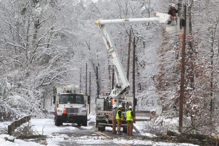   An Entergy Arkansas Inc., crew works to restore power to customers on Whittington Avenue near the entrance to Hot Springs National Park, Thursday, Dec. 27, 2012, in Hot Springs, Ark. A Christmas Day storm dumped between 6 to 15 inches of snow knocking out power to about half of the 61,000 customers in Garland County. (AP Photo/The Sentinel-Record, Richard Rasmussen)  