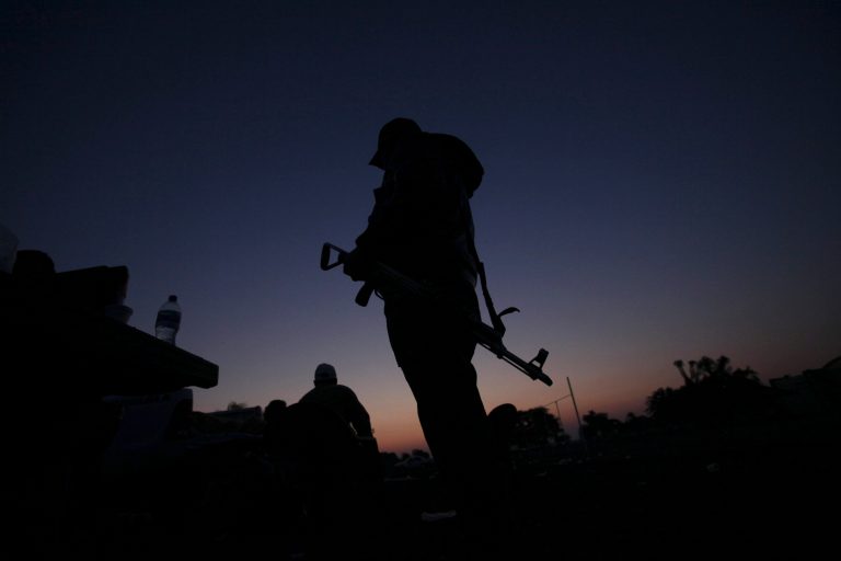 FILE - In this Feb. 9, 2014, file photo, an armed man from a self-defense group stands with his weapon at the entrance of Apatzingan in Michoacan state, Mexico. Prosecutors in western Mexico announced this Wednesday April 16, 2014 that they arrested the mayor of Apatzingan that once served as a stronghold of the Knights Templar drug cartel on charges that he helped the gang extort money from city council members. (AP Photo/Marco Ugarte, File)