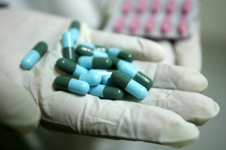 A medical worker shows capsules as he works at the Middle East Company for Pharmaceutical Industries September 08, 2008 in Bait Hanoun, Gaza Strip. (Photo by Abid Katib/Getty Images)