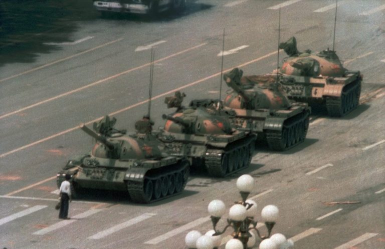 A Chinese man stands alone to block a line of tanks heading east on Beijing's Cangan Blvd. in Tiananmen Square on June 5, 1989. The man, calling for an end to the recent violence and bloodshed against pro-democracy demonstrators, was pulled away by bystanders, and the tanks continued on their way. The Chinese government crushed a student-led demonstration for democratic reform and against government corruption, killing hundreds, or perhaps thousands of demonstrators in the strongest anti-government protest since the 1949 revolution. (AP Photo/Jeff Widener)