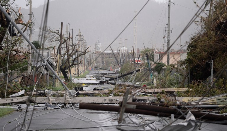 Electricity poles and lines lay toppled on the road after Hurricane Maria hit the island. President Trump said Thursday that he would soon visit Puerto Rico to take stock of the damage. (AP Photo/Carlos Giusti)