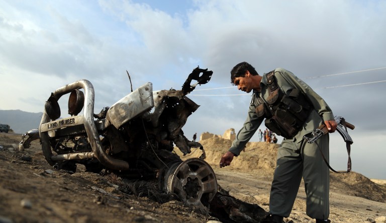 An Afghan security force check the site a day after an an attack near the Bagram Air Base, north of Kabul, Afghanistan, Tuesday, April 9, 2019.
