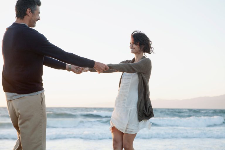A couple dances on the beach.