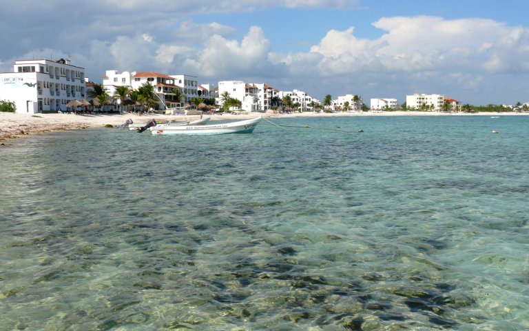 A picture of Half Moon Bay in Akumal, Mexico, is shown.