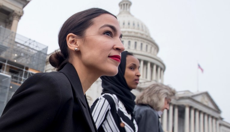 Rep. Alexandria Ocasio-Cortez, left, and D-N.Y., Rep. Ilhan Omar, D-Minn., center, walk down the House steps to take a group photograph of the House Democratic women members of the 116th Congress on the East Front Capitol Plaza on Capitol Hill in Washington, Friday, Jan. 4, 2019, as the 116th Congress begins. Also pictured is Rep. Dina Titus, D-Nev., right.
