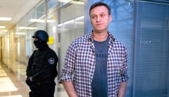 Putin critic Alexei Navalny able to leave bed as he recovers from poisoning