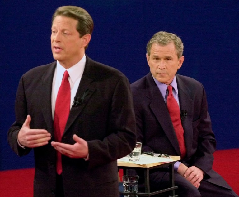 Democratic presidential candidate Vice President Al Gore, left, speaks as Republican presidential candidate Texas Gov. George W. Bush watches during their debate at Washington University Tuesday, Oct. 17, 2000, in St. Louis.