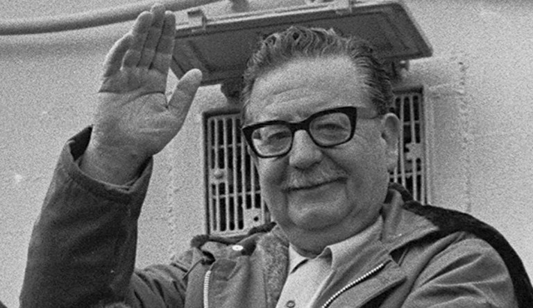 In this 1971 photo, President Salvador Allende waves to supporters in Chile. 