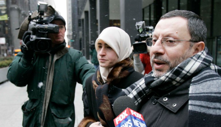 Abdelhaleem Ashqar is surrounded by cameramen as he leaves federal court with his wife, Thursday, Feb. 1, 2007, in Chicago. 