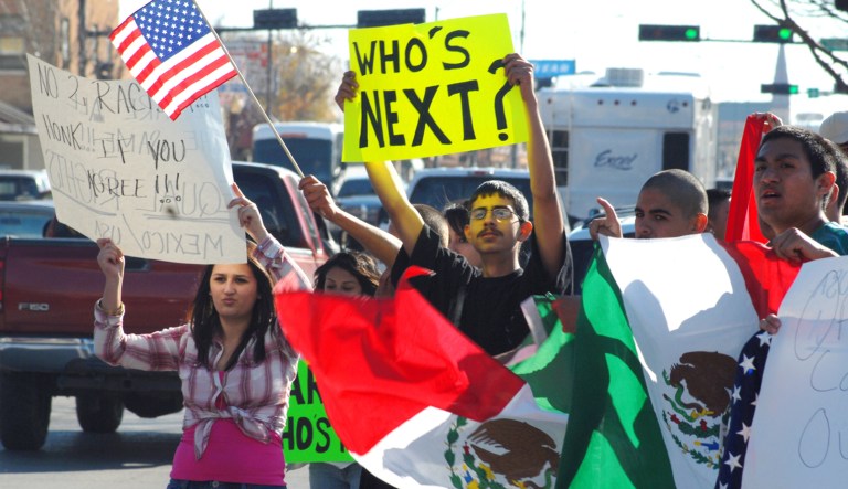 Demonstrators lend their supporters for a deported student as they wave signs and flags in New Mexico. 