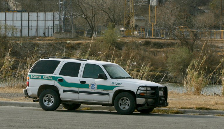 A U. S. Border Patrol vehicle sits along the Rio Grande in Eagle Pass, Texas.