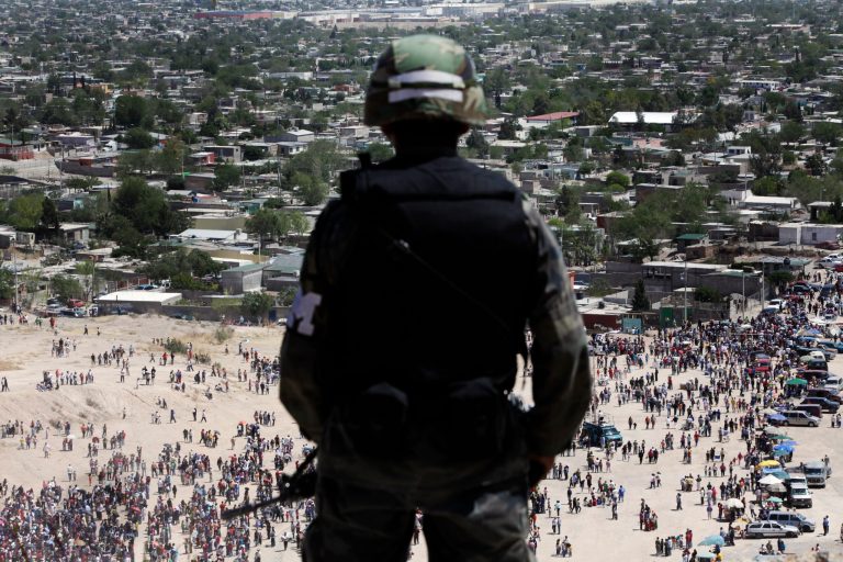 A soldier stands guard on the top of a hill as faithful commemorate Good Friday during Holy Week in Ciudad Juarez, Mexico, Friday, April 10, 2009. Drug violence has spiked since President Felipe Calderon began a national crackdown on organized crime in 2006. Battles among cartels, their rivals and soldiers have led to nearly 9,000 deaths and a cross-border crime spillover.