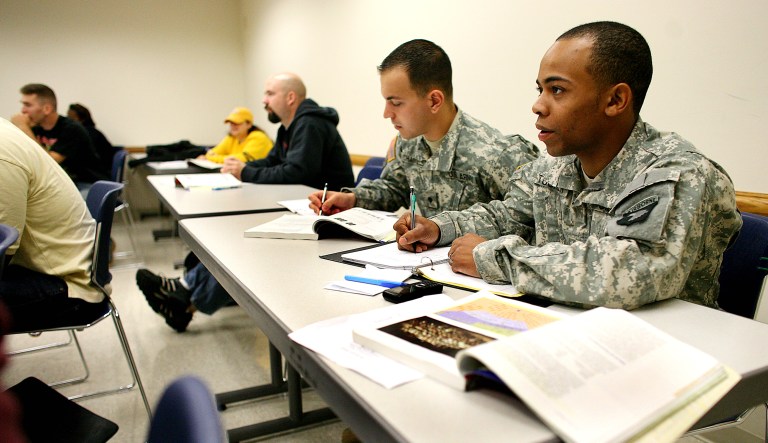Specialist Steffen Tucker, right, and Specialist Stephen Channels, second from right, take notes during a class.