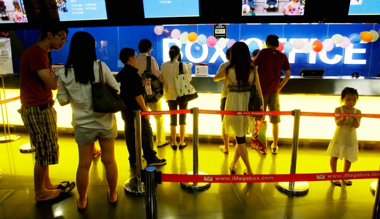 Chinese people line up to buy movie tickets at a theater in Beijing, China.