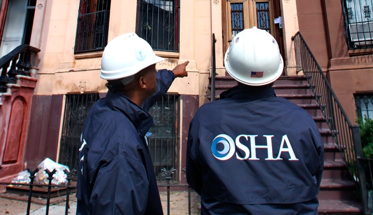 OSHA inspectors survey homes that lost roofs in the aftermath of a fierce storm, along Quincy Avenue in the Bedford-Stuyvesant, Brooklyn, New York.