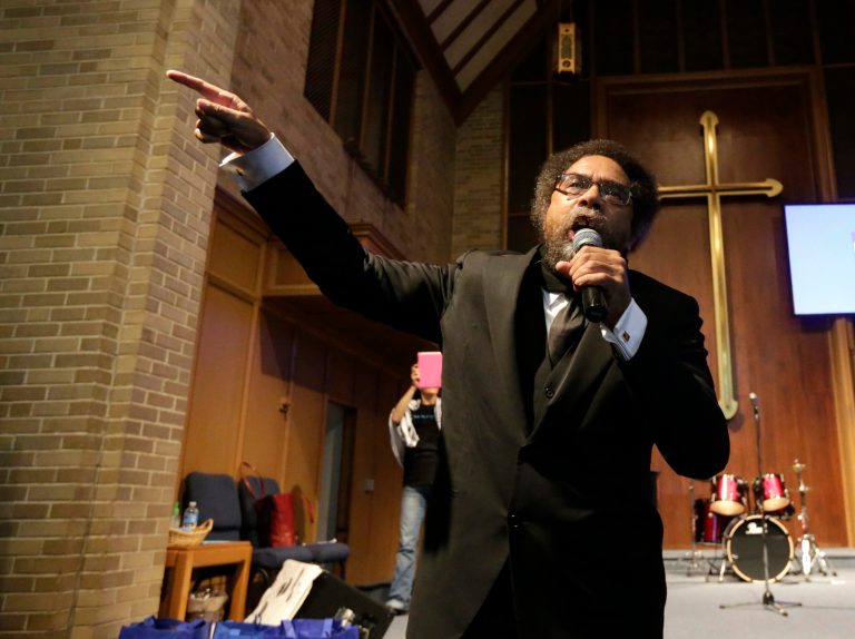 Cornel West talks to protesters before a march to the Ferguson, Mo.