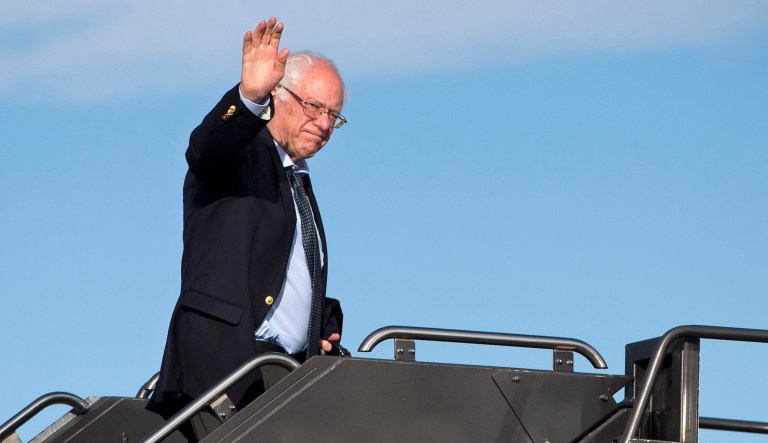 Democratic presidential candidate Sen. Bernie Sanders, I-Vt., waves as he boards his plane in Denver.