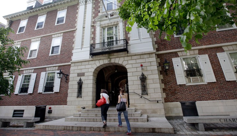 Students walk into Kirkland House on the campus of Harvard University in Cambridge, Mass. Wednesday, May 16, 2012.