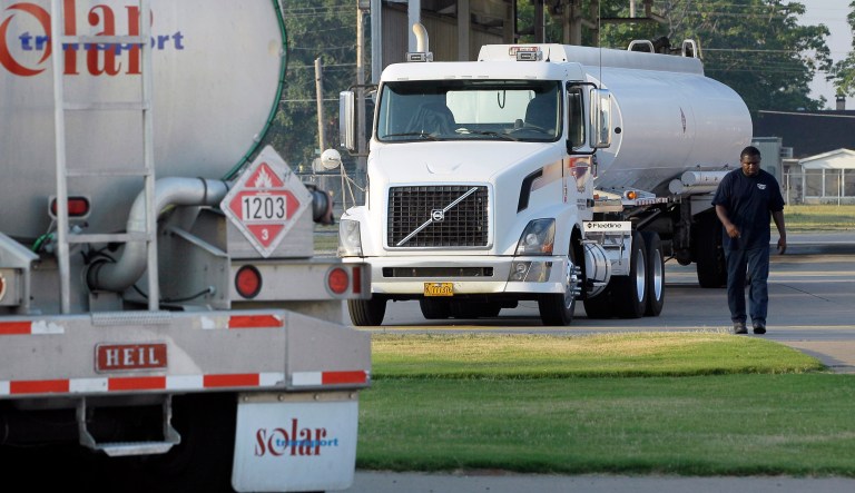 A man walks from a gasoline tanker truck at a North Little Rock, Ark., fuel distribution terminal, Friday, June 29, 2012. Oil soared the most in more than three years, on Friday, after European leaders took surprisingly aggressive steps meant to halt a debt crisis that has undermined the regional economy.