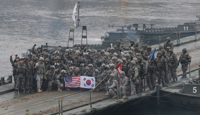 U.S. and South Korean army soldiers pose on a floating bridge on the Hantan River after a river crossing operation, part of an annual joint military exercise between South Korea and the United States. 