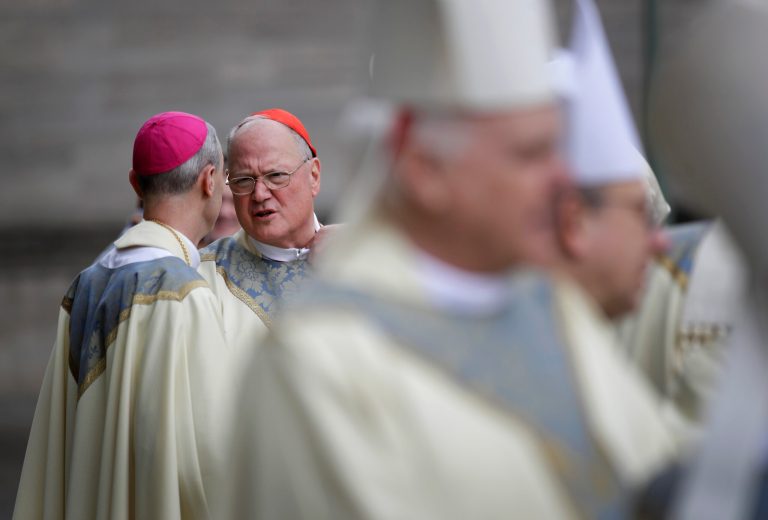 Cardinal Timothy Dolan of New York chats a funeral Mass for Cardinal William Keeler at the Cathedral of Mary Our Queen in Baltimore, Tuesday, March 28, 2017.