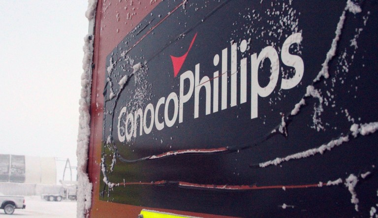 FILE - This Feb. 9, 2016, file photo shows an ice-covered ConocoPhillips sign at the Colville-Delta 5, or as it's more commonly known, CD5, drilling site on Alaska's North Slope. ConocoPhillips reports financial results Thursday, April 28, 2016.