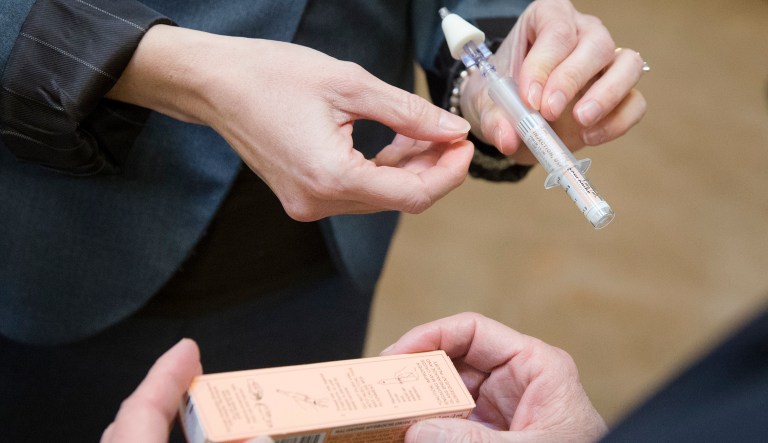 A naloxone nasal injector is demonstrated during a news conference. It is becoming easier for friends and family of heroin users or patients abusing strong prescription painkillers to get access to naloxone, a powerful, life-saving antidote, as state lawmakers loosen restrictions on the medicine to fight a growing epidemic. 