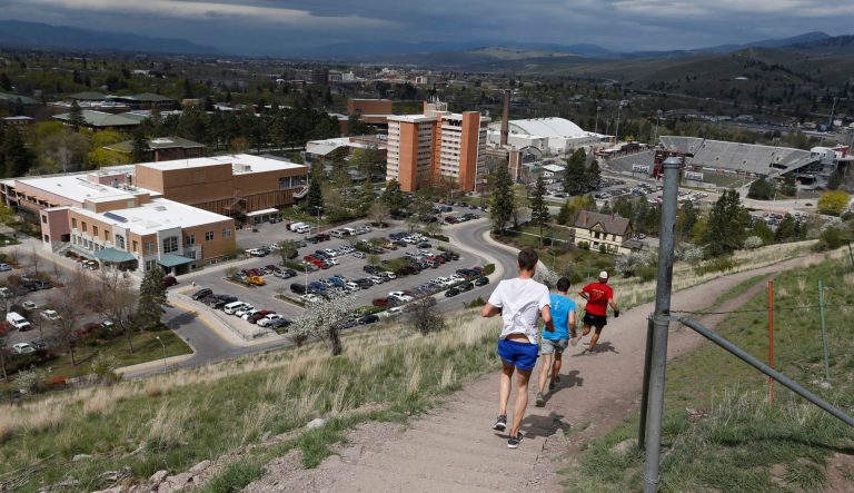In this April 12, 2016 photo, runners make their way down a hillside overlooking the University of Montana campus in Missoula, Mont. 