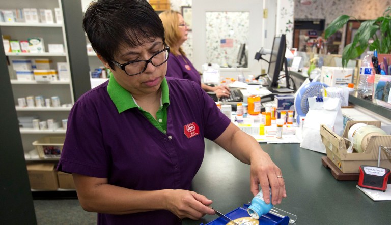 A person fills a prescription for a patient.