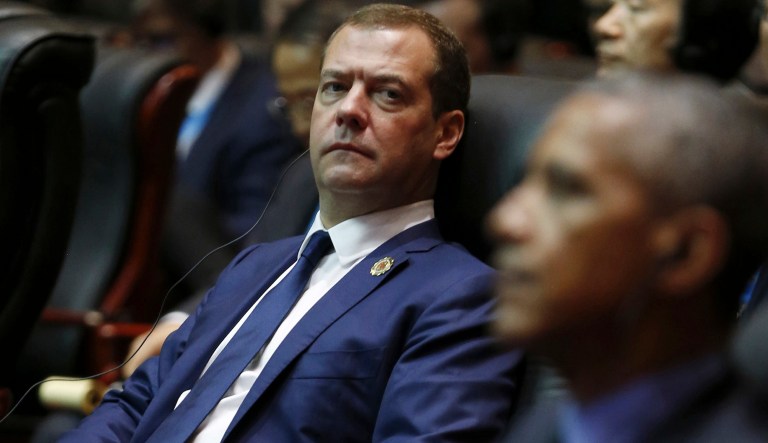 Russian Prime Minister Dmitry Medvedev, left, looks at President Barack Obama, foreground right, as they attend the 11th East Asia Summit at National Convention Center in Vientiane, Laos, Thursday, Sept. 8, 2016. 