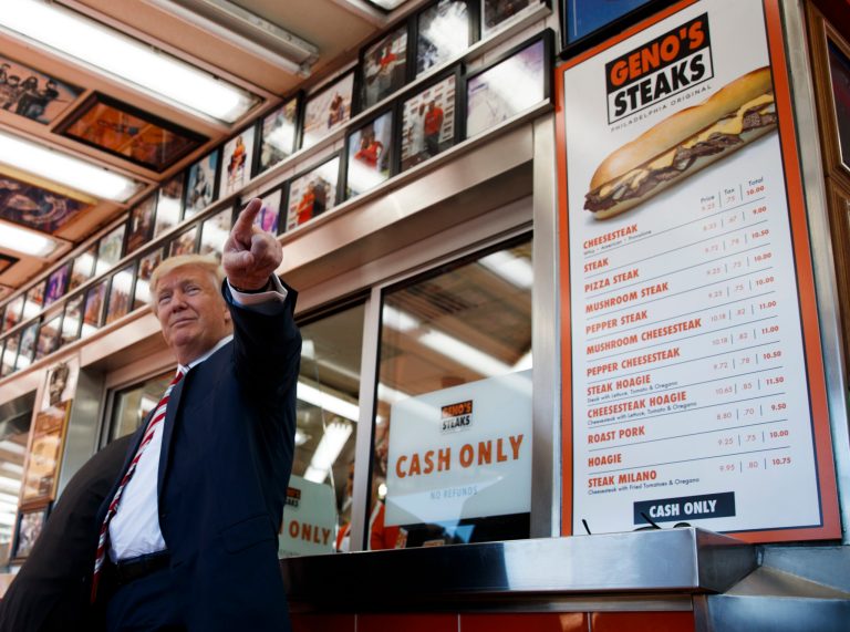FILE - In this Sept. 22, 2016 file photo, Republican presidential candidate Donald Trump talks with customers during a visit to Geno's Steaks in Philadelphia. Trump once claimed to be publicity shy, no joke. Itâs right there in The New York Times of Nov. 1, 1976. In the same article, the 30-year-old real estate developer talks up his millions, showcases his penthouse apartment and Cadillac, and allows a reporter to tag along as he visits job sites and lunches at the â21â club before hopping an evening flight to California for more deal-making. So much for that shy-guy claim.