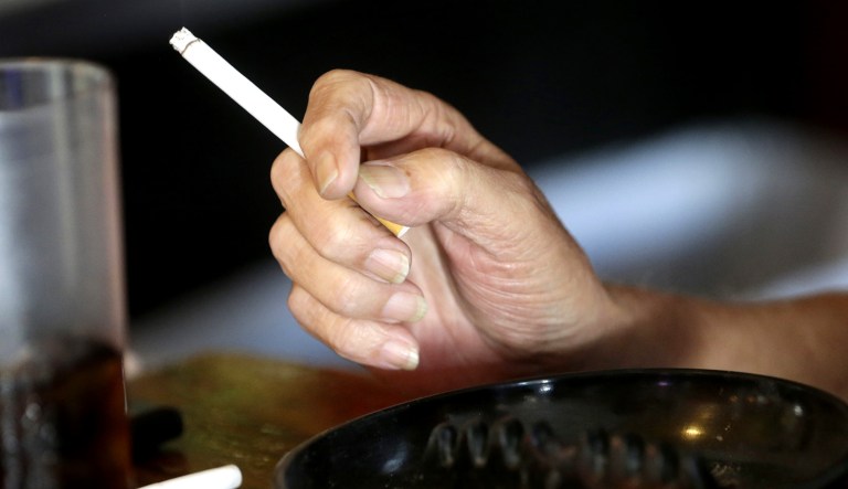 A patron smokes a cigarette inside a bar in New Orleans.