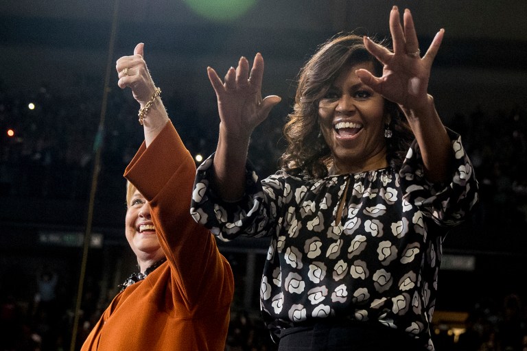 Democratic presidential candidate Hillary Clinton, accompanied by first lady Michelle Obama, takes the stage at a campaign rally at Wake Forest University in Winston-Salem, N.C., Thursday, Oct. 27, 2016.