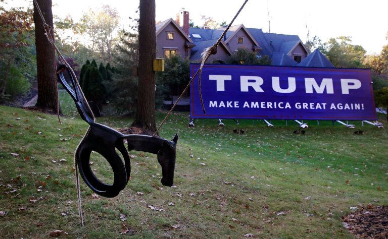 A child's swing hangs near a giant Trump campaign yard sign, which nearly dwarfs the Antico family, six-bedroom home, in Wayland, Mass., Tuesday, Nov. 1, 2016. A new survey shows 26% feel "unsafe" living next to avid Trump backers.