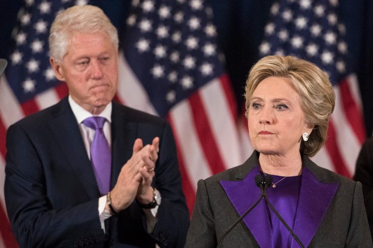 Former President Bill Clinton applauds as his wife, Democratic presidential candidate Hillary Clinton speaks in New York, Wednesday, Nov. 9, 2016, where she conceded her defeat to Republican Donald Trump after the hard-fought presidential election.