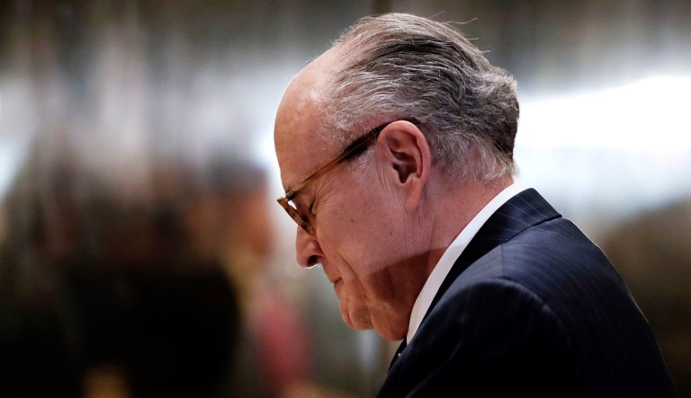 Former New York City Mayor Rudy Giuliani pauses as he arrives at Trump Tower in New York.