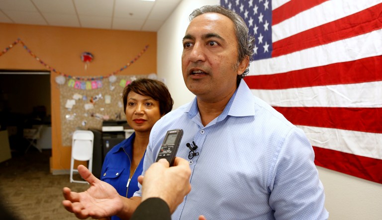 Rep. Ami Bera, D-Elk Grove, flanked by his wife, Janine, talks to reporters.