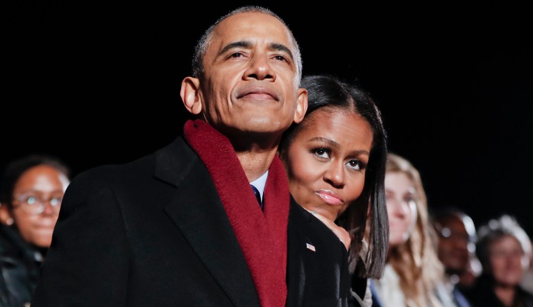 President Barack Obama and first lady Michelle Obama embrace as they watch the musical performances at the 2016 National Christmas Tree lighting ceremony at the Ellipse near the White House in Washington, Thursday, Dec. 1, 2016. 