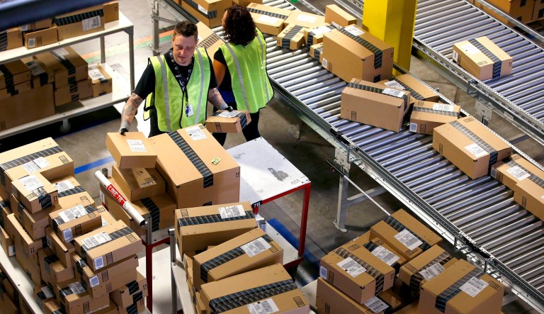 FILE - In this Dec. 2, 2013 file photo, Amazon.com employees organize outbound packages at an Amazon.com Fulfillment Center on "Cyber Monday" the busiest online shopping day of the holiday season, in Phoenix. Buying things online could soon get pricier for many people after the U.S. Supreme Court's decision Monday, Dec. 12, 2016 not to get involved in a case that may lead to states collecting billions in lost sales taxes. The court opted not to hear a challenge to a Colorado law requiring internet retailers to notify customers and the state how much they owe in Colorado taxes. 