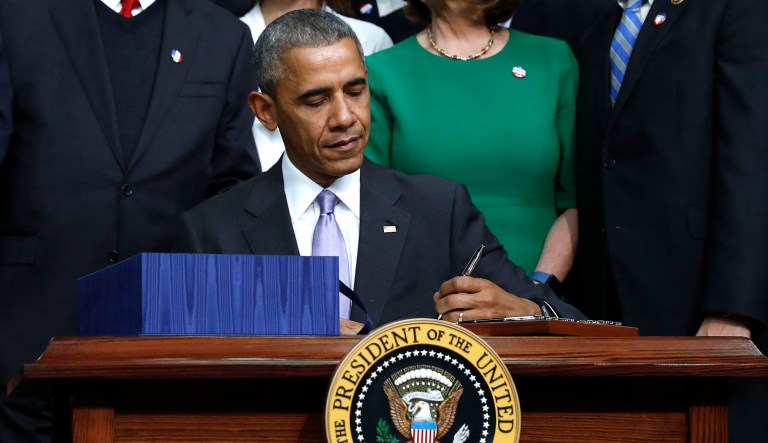 Then-President Barack Obama signs a bill in Washington.
