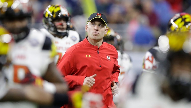 Maryland head coach DJ Durkin runs onto the field before the Quick Lane Bowl NCAA college football game against Boston College.