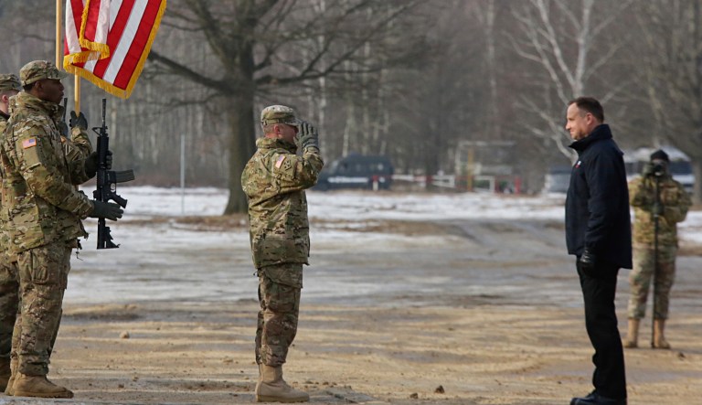 Polish President Andrzej Duda, right, stands in front of a saluting U.S. Army soldier during the opening of joint Polish and U.S. exercise on training fields in Zagan, Poland, Monday, Jan. 30, 2017.