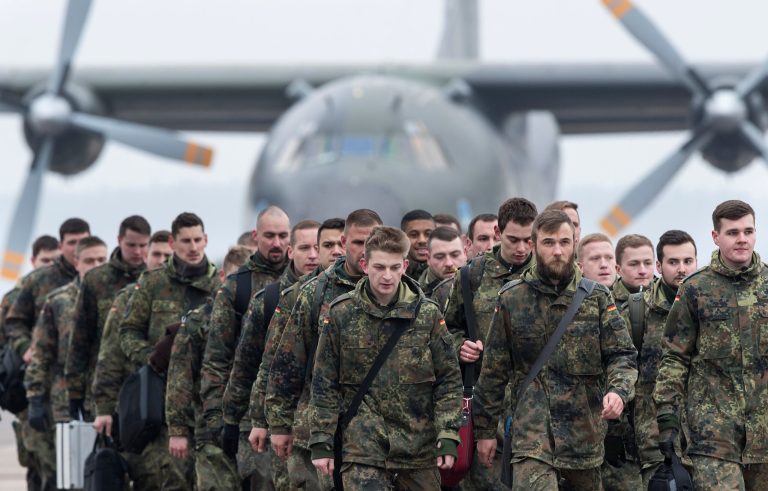 German Bundeswehr soldiers of the 12th Mechanised Infantry Brigade, 122th Infantry Battalion arrive at an airport in Kaunas, Lithuania, Wednesday, Feb. 1, 2017. German troops and tanks are en route to central Lithuania as part of NATO's move to enhance its presence in the alliance's easternmost countries as a deterrent against Russian aggression. The German military said Tuesday that 36 vehicles, including Boxer armored fighting vehicles, were being loaded on a train in Bavaria for the trip to Rukla.