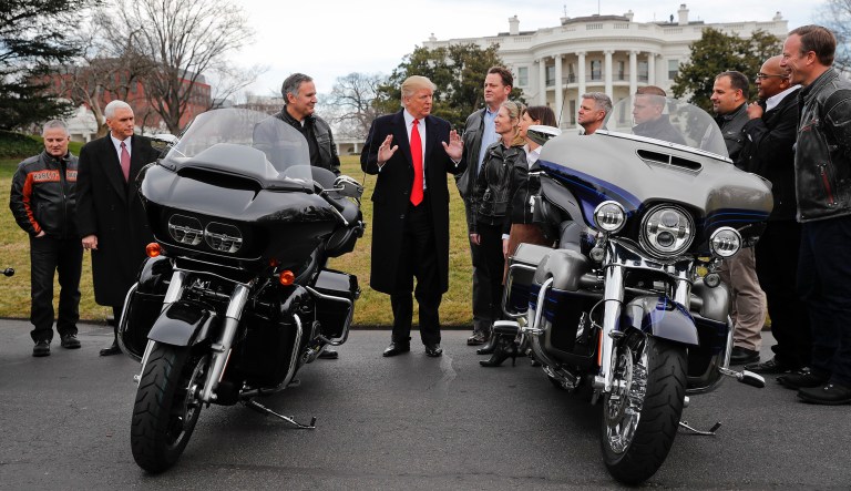 President Donald Trump and Vice President Mike Pence meet with meet with Harley-Davidson executives shortly after Trump's 2017 inauguration. The president lambasted the company Tuesday for its decision to move some production outside of the U.S. to escape the impact of trade disputes he initiated.