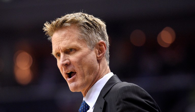 Golden State Warriors head coach Steve Kerr reacts during an NBA basketball game.