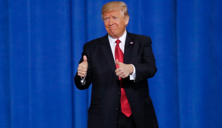 President Donald Trump gives thumbs up at an event in Ypsilanti Township, Mich.