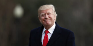 President Trump smiles after returning from a trip to his Mar-a-Lago estate in Palm Beach, Fla.