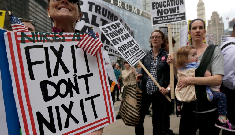 Protesters gather across the Chicago River from Trump Tower to rally against the repeal of the Affordable Care Act Friday, March 24, 2017, in Chicago. Earlier, President Donald Trump and GOP leaders yanked their bill to repeal "Obamacare" off the House floor Friday when it became clear it would fail badly.